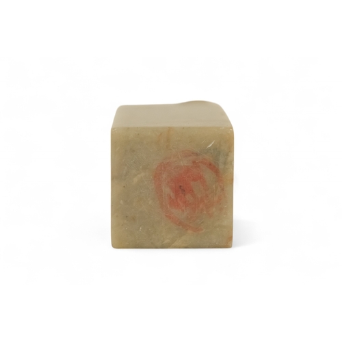 336 - A 20th century Chinese soapstone seal - with square blank matrix and surmounted by a dog of fo, 7cm ... 