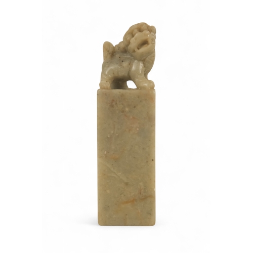 336 - A 20th century Chinese soapstone seal - with square blank matrix and surmounted by a dog of fo, 7cm ... 