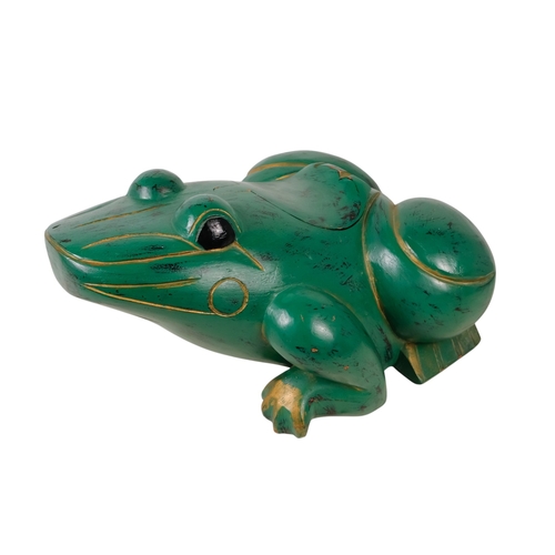 36 - An Indonesian green painted wooden frog - with gilt decoration and a hinged compartment to its back,... 