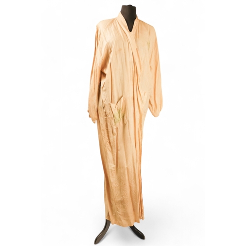 396 - A cream silk dressing gown - embroidered in green with a dragon chasing the flaming pearl and with c... 