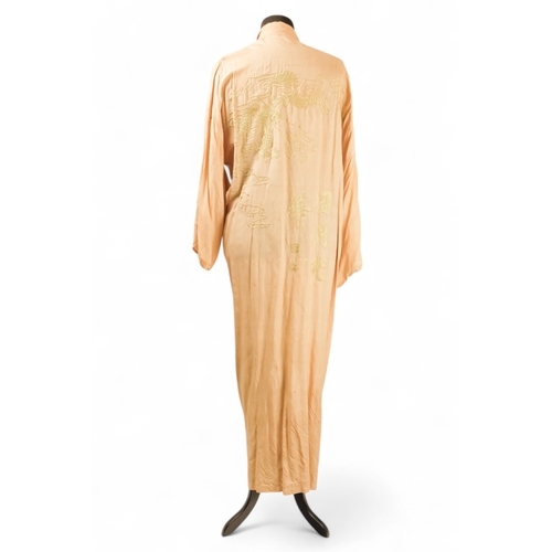 396 - A cream silk dressing gown - embroidered in green with a dragon chasing the flaming pearl and with c... 