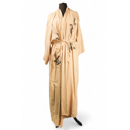 396 - A cream silk dressing gown - embroidered in green with a dragon chasing the flaming pearl and with c... 