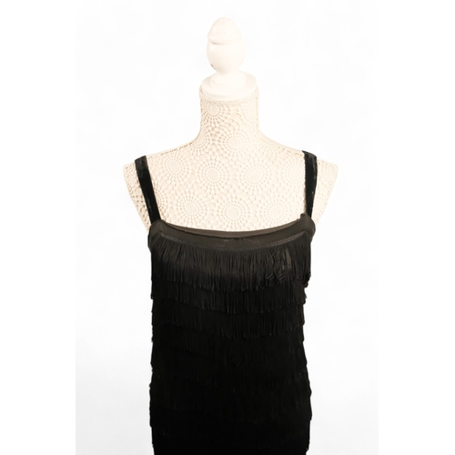 397 - A black 'Flapper' style dress - with black velvet straps, size 10/12, length 90cm.