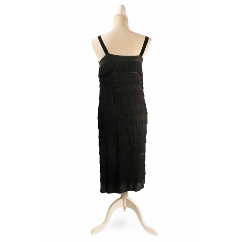 397 - A black 'Flapper' style dress - with black velvet straps, size 10/12, length 90cm.