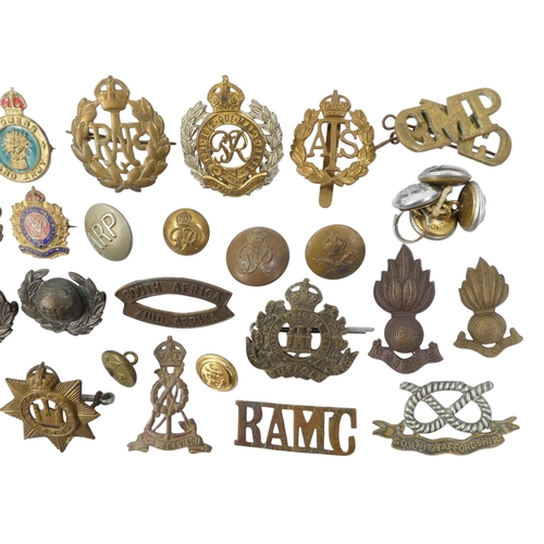 436 - A quantity of 20th century military badges and buttons.