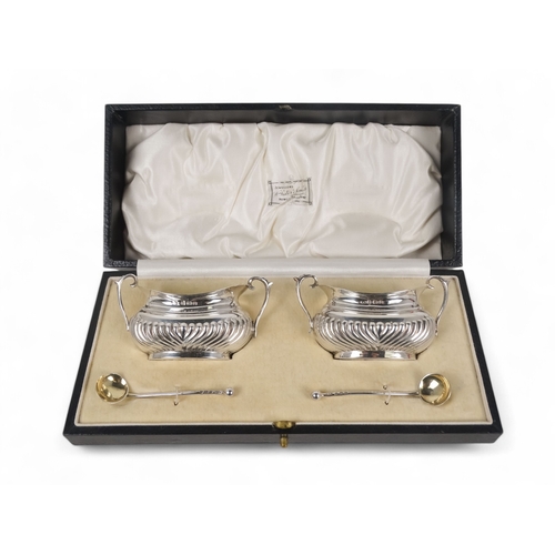 497 - A pair of silver salts - Brimingham 1902, twin handled and part gadrooned with a gilt lining, boxed ... 