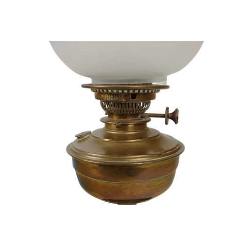 51 - A late 19th century oil lamp - with ruby glass reservoir and fluted baluster support and circular ba... 