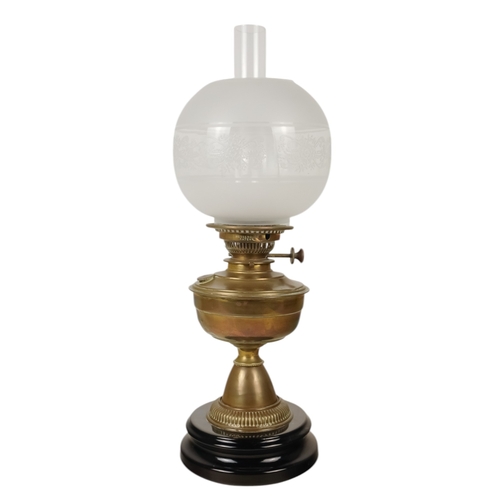 51 - A late 19th century oil lamp - with ruby glass reservoir and fluted baluster support and circular ba... 