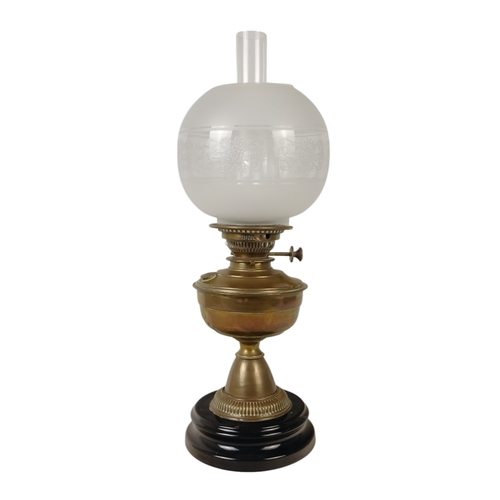 51 - A late 19th century oil lamp - with ruby glass reservoir and fluted baluster support and circular ba... 