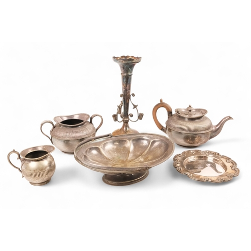 556 - A small quantity of plated wares - including a three piece tea service, part fluted, together with s... 