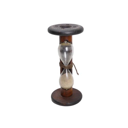 57 - An egg timer formed from a spinning bobbin - runs to three minutes, 24cm high.