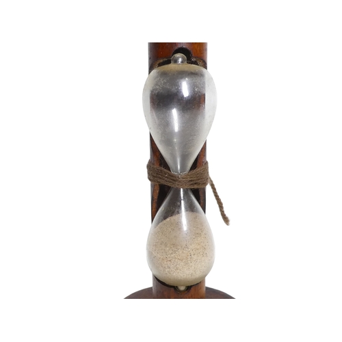 57 - An egg timer formed from a spinning bobbin - runs to three minutes, 24cm high.