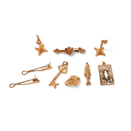 576 - A pair of 9ct gold charms - modelled as columns, together with three further charms, a pendant, a br... 