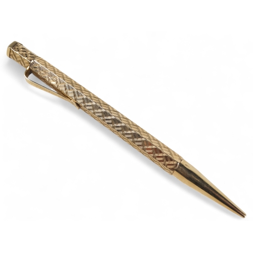 578 - A 9ct gold pencil - hexagonal with engine turning and a vacant cartouche, retailed by Wilson & Gill,... 