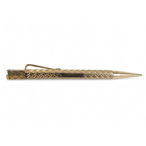 578 - A 9ct gold pencil - hexagonal with engine turning and a vacant cartouche, retailed by Wilson & Gill,... 