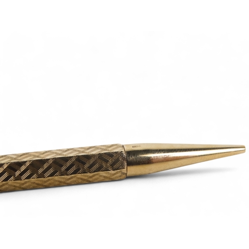 578 - A 9ct gold pencil - hexagonal with engine turning and a vacant cartouche, retailed by Wilson & Gill,... 