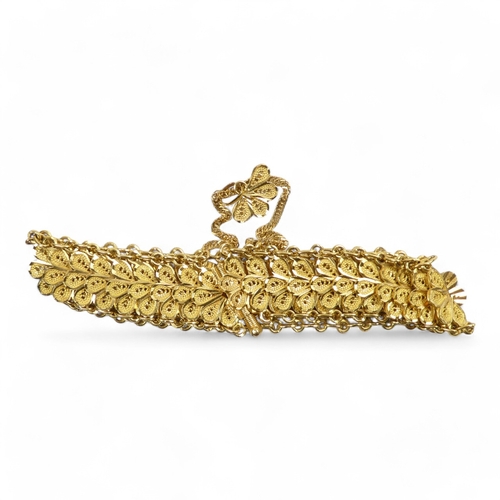 584 - A yellow metal bracelet - of pierced foliate form linked by chain, stamped 21ct, 37.8g.