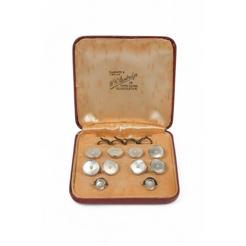 593 - A 9ct white gold pearl and mother-of-pearl stud set - boxed, 11g.