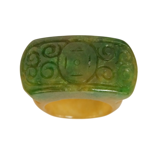 610 - A jadeite archers ring - with rectangular carved face.