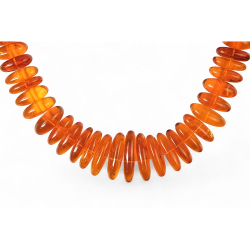 614 - A string of amber beads - length 50cm, together with a further string of amber beads.