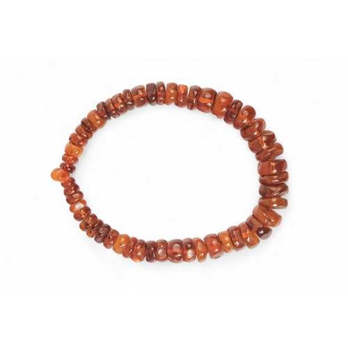 615 - A string of bullet shaped graduated amber beads - length 76cm.