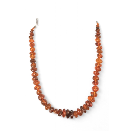 615 - A string of bullet shaped graduated amber beads - length 76cm.