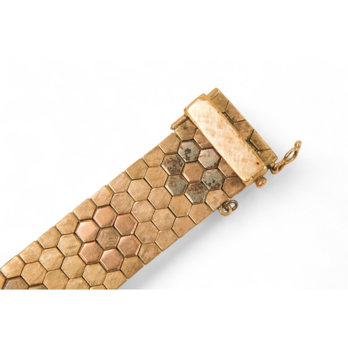 617 - A 9ct gold bracelet - of belt form constructed of articulated hexagons, 43.6g.