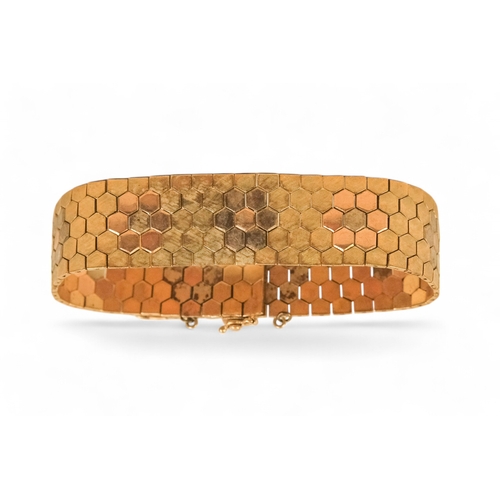 617 - A 9ct gold bracelet - of belt form constructed of articulated hexagons, 43.6g.