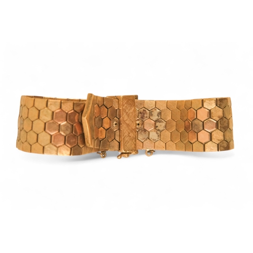 617 - A 9ct gold bracelet - of belt form constructed of articulated hexagons, 43.6g.