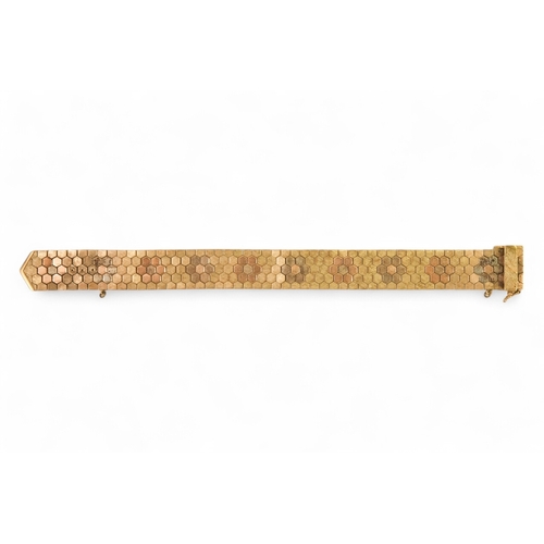 617 - A 9ct gold bracelet - of belt form constructed of articulated hexagons, 43.6g.