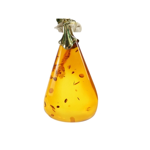 627 - An amber pendant - of polished triangular form, on a 9ct belcher link chain, 11.1g.