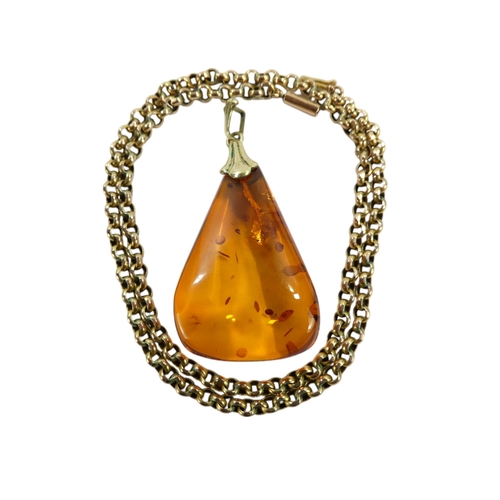 627 - An amber pendant - of polished triangular form, on a 9ct belcher link chain, 11.1g.