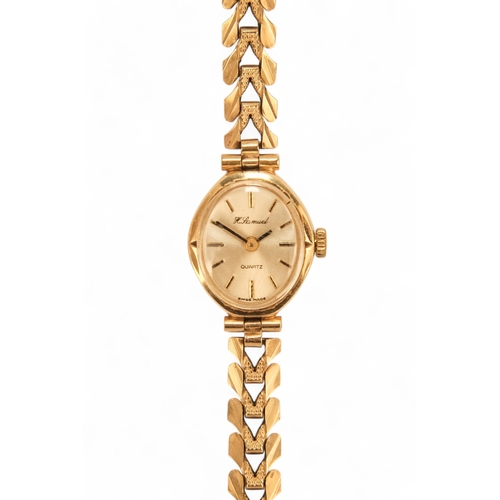 704 - A ladies 9ct gold cocktail watch - oval with a cream dial set out in baton numerals, 10.2g all in, t... 