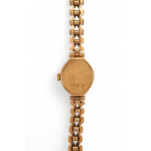 704 - A ladies 9ct gold cocktail watch - oval with a cream dial set out in baton numerals, 10.2g all in, t... 