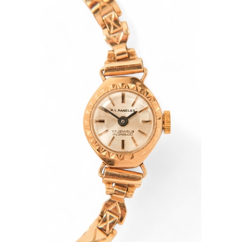 704 - A ladies 9ct gold cocktail watch - oval with a cream dial set out in baton numerals, 10.2g all in, t... 