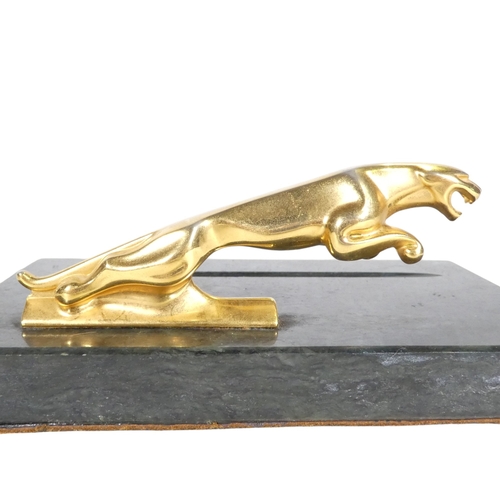 75 - A marble pen tray - mounted with a leaping Jaguar, 18cm wide.