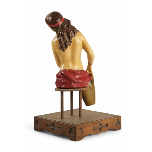 78 - An 'Old Charm Furniture' point of sale figure - modelled as a water-carrier, on a square oak base, 2... 