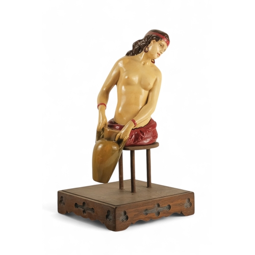 78 - An 'Old Charm Furniture' point of sale figure - modelled as a water-carrier, on a square oak base, 2... 