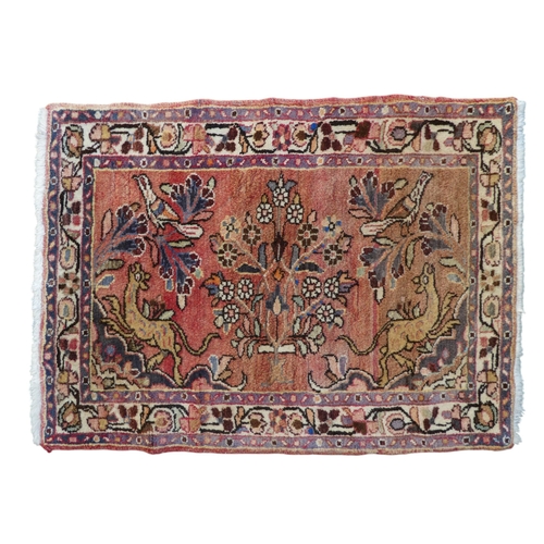 869 - A Persian rug - the madder ground decorated with deer, birds and flowers, 76 x 104cm, together with ... 