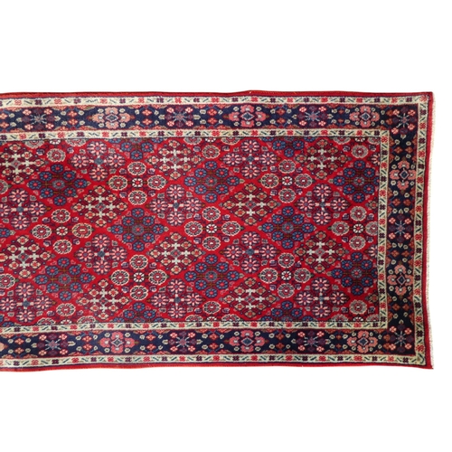 870 - A Persian Hamadan runner - the madder ground with floral decoration and multiple borders, 74 x 360cm... 