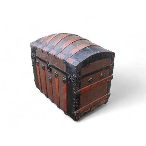 902 - A late 19th century domed trunk - tin on a wooden frame and lathes with steel brackets, 90 x 54 x 79... 