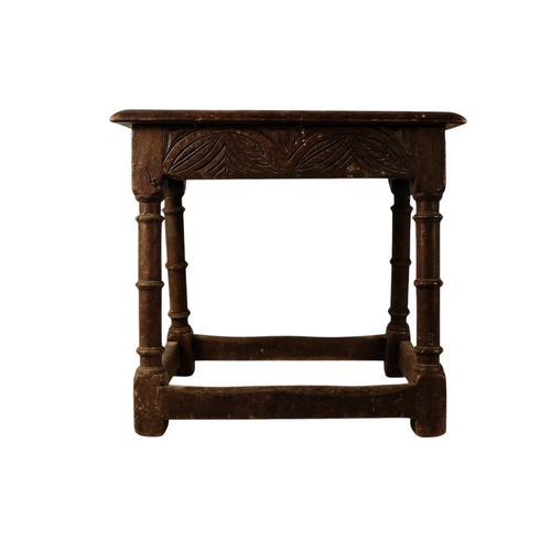 922 - A 17th century and later oak joint stool - the moulded rectangular seat above guilloche carved friez... 