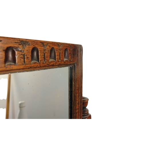 934 - A 17th century style oak toilet mirror - with a rectangular plate and fluted carving between turned ... 