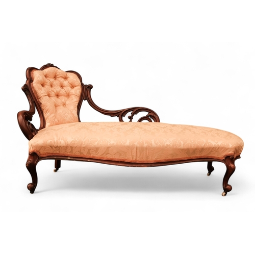 937 - A Victorian walnut and upholstered chaise longue - the button upholstered back with pierced foliate ... 