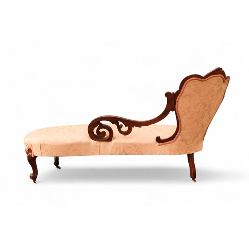 937 - A Victorian walnut and upholstered chaise longue - the button upholstered back with pierced foliate ... 