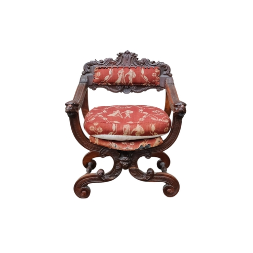 942 - A 17th century style continental walnut Savonarola chair - with carved lion mask finials.