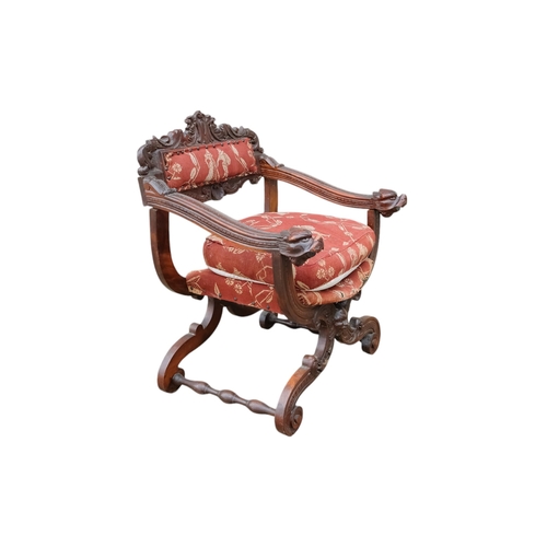 942 - A 17th century style continental walnut Savonarola chair - with carved lion mask finials.