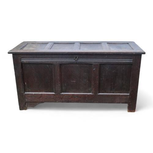 948 - A 17th century style oak refectory table - the rectangular plank top above square and baluster turne... 