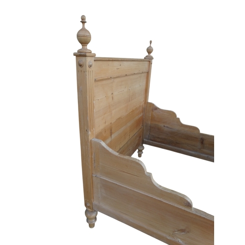 949 - A late 19th century French pine lit-en-bateau - with panelled foot and head boards, 117cm wide.