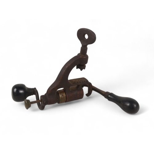 14 - A 19th century shotgun cartridge loading tool - cast iron with brass fittings and ebony handles.